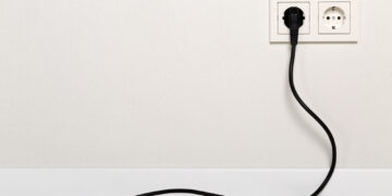 Why do some devices have plugs with two prongs, and others have three to work?